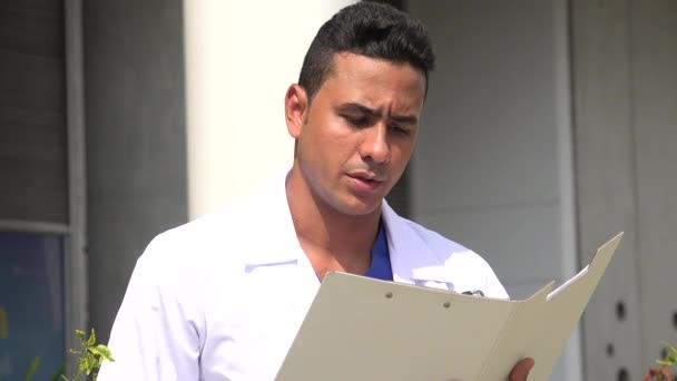 Serious Hispanic Male Doctor Reading — Stock Video