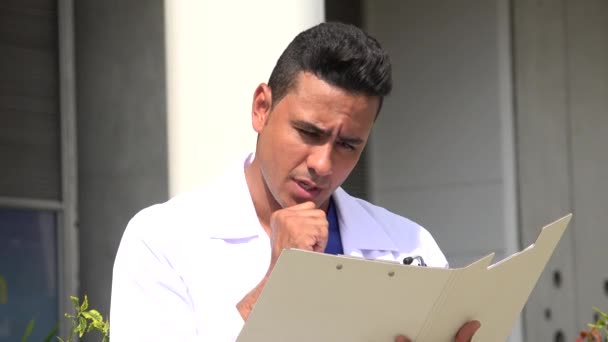 Hispanic Male Doctor Thinking Reading — Stock Video