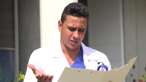 Confused Hispanic Male Doctor Reading — Stock Video