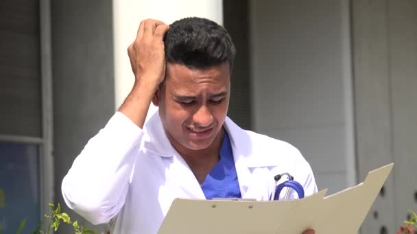 Stressed Hispanic Male Doctor Reading — Stock Video