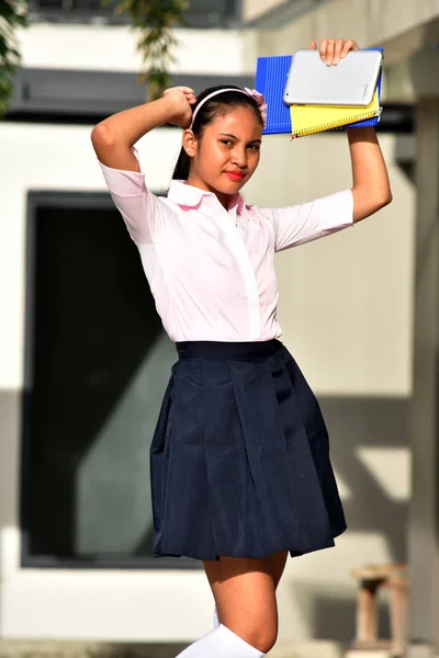 Young Minority Female Student Dancing With Books