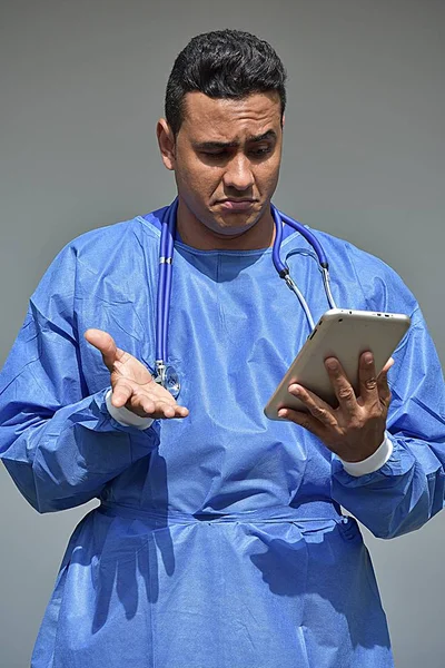 Confused Male Doctor With Tablet