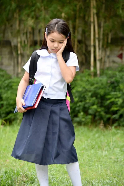 Sad Young Filipina Female Student With Notebooks