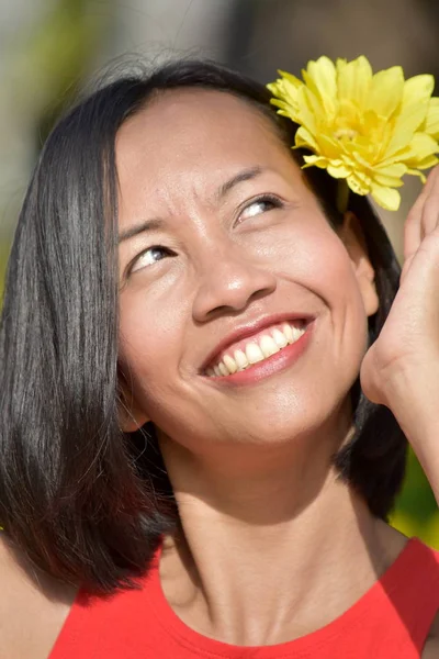 Portrait Of A Young Minority Person With A Flower