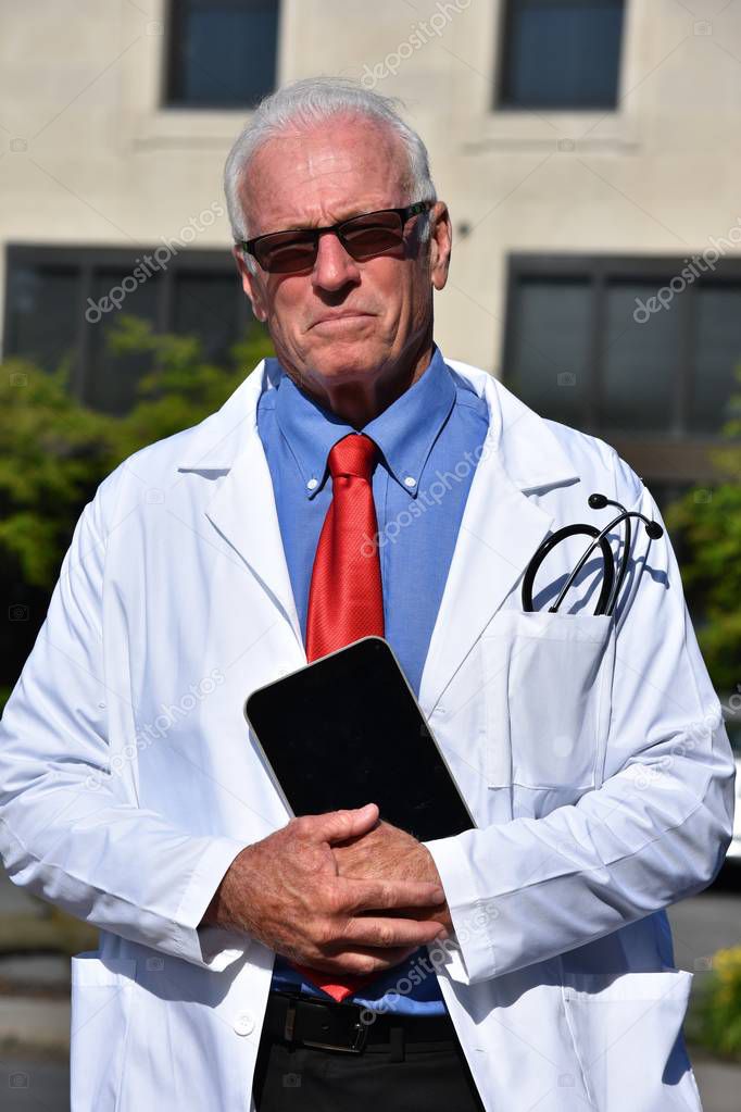 Unemotional Male Medic Wearing Lab Coat At Hospital