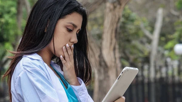 Confused Cute Peruvian Female Doctor Wearing Lab Coat