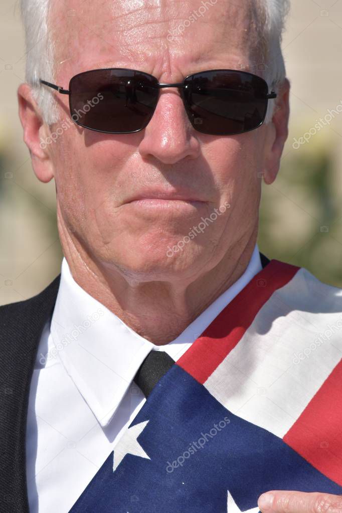 Unemotional Adult Senior Male Politician Wearing Business Suit With Usa Flag