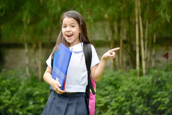 Apontando jovem minoria criança menina estudante vestindo uniforme escolar — Fotografia de Stock