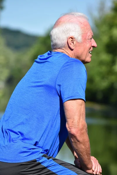 Stretching Athletic Male Senior Outdoors