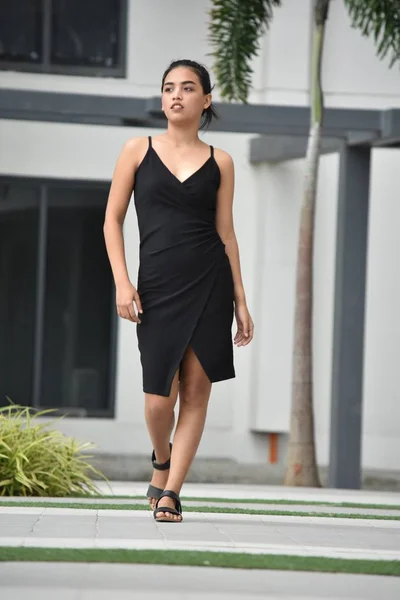 Unemotional Young Asian Youth Wearing A Dress Walking