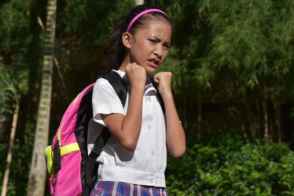 Disgustada linda chica estudiante usando uniforme escolar con cuadernos — Foto de Stock