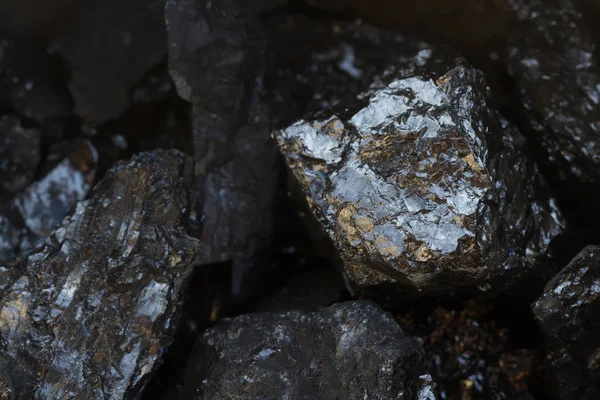 Black coal mine close-up with soft focus. Anthracite coal bar on dark background. Natural black coal bars for background. Industrial coal nuggets close up