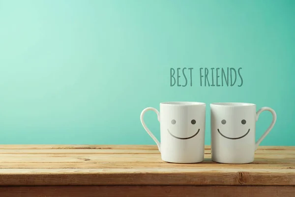 Coffee Cups Funny Faces Wooden Table Friendship Day Celebration Background — Stock Photo, Image