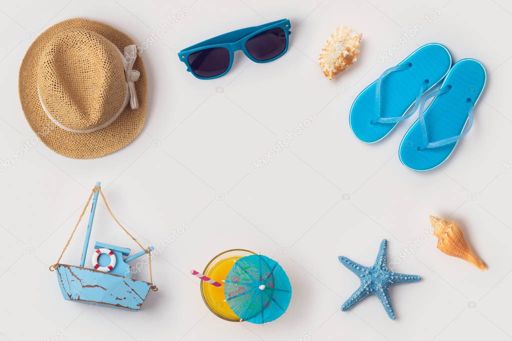 Travel holiday vacation concept with beach and travel items organized on white background. Top view from above. Flat lay