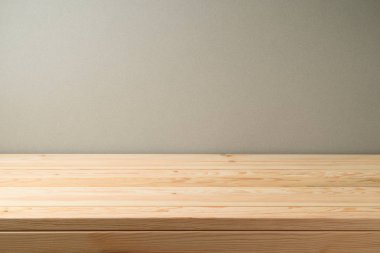 Empty wooden table over grey wall background. Can be used for food stand. key visual layout  or new product advertising display clipart