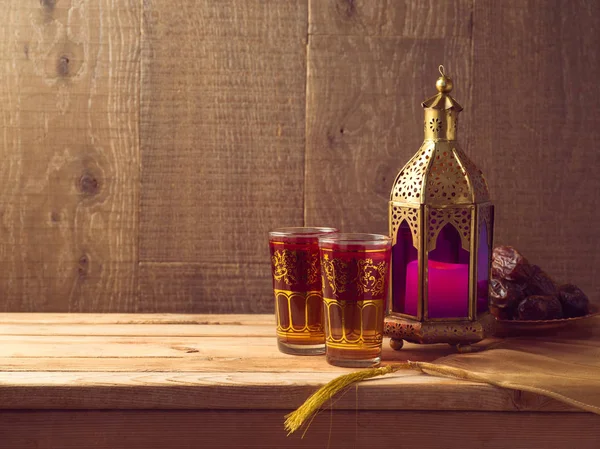 Lightened lantern, tea and dates fruit — Stock Photo, Image