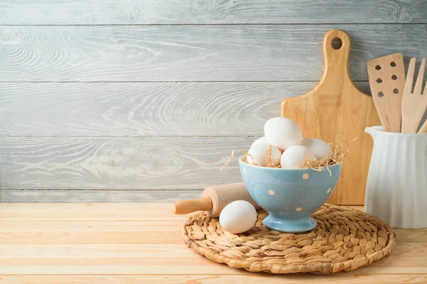 Easter baking background with eggs and kitchen utensils on woode — Stock Photo, Image