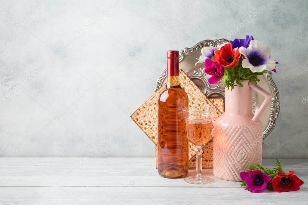 Jewish holiday Passover background with flowers, wine, matzo and
