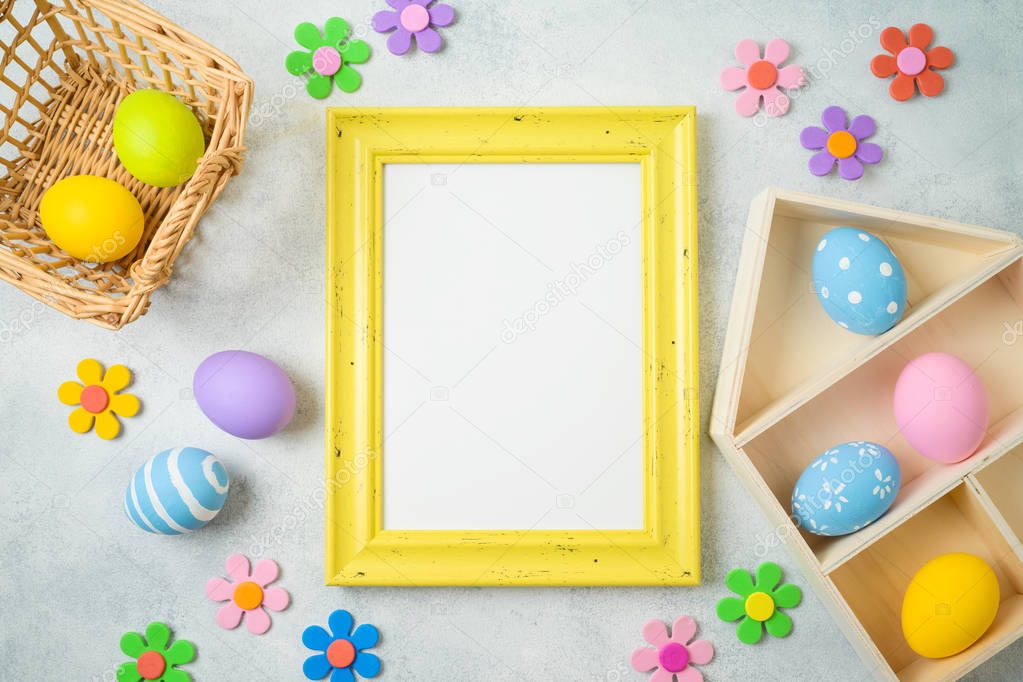 Easter holiday background with easter eggs and photo frame on ta