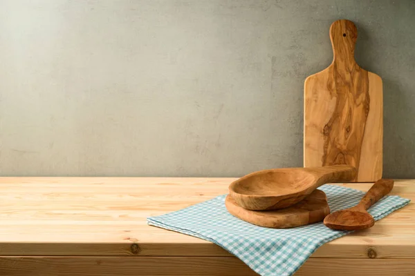 Kitchen olive wood utensils on wooden table.