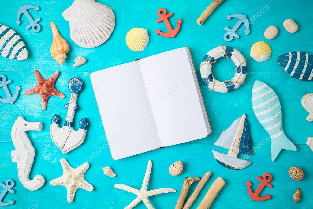 Summer background with notebook and nautical decorations on wood
