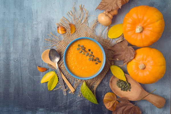 Pumpkin soup on rustic background. Autumn concept with pumpkin a