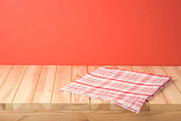 Christmas empty wooden table with tablecloth over red festive ba — ストック写真