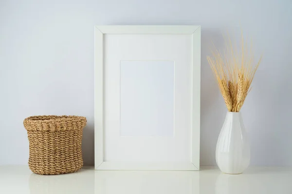 White frame mock up with home decor objects on table background