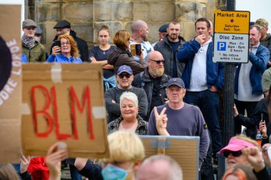 Richmond, Kuzey Yorkshire, İngiltere - 14 Haziran 2020: Kızgın Karşı Protestocular, Siyahların Yaşamları Konusu protestosuna karşı Richmond Pazarında toplandılar. Ön planda ev yapımı BLM işareti var..