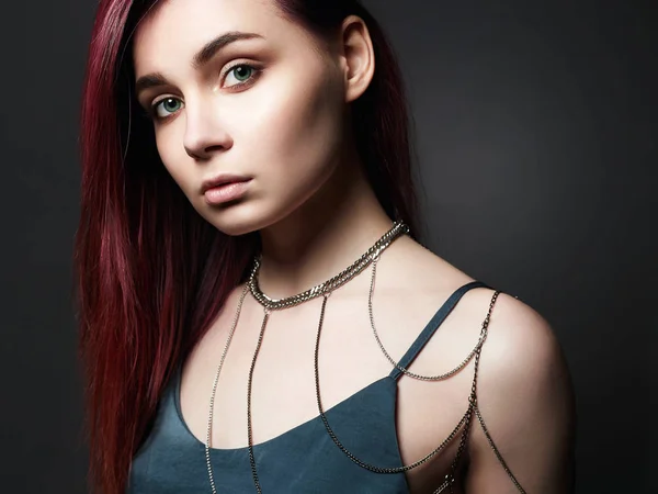 Sensual Girl with color hair and chain necklace on the shoulder. Beautiful sexy Young woman. Trendy Dyed Hair color
