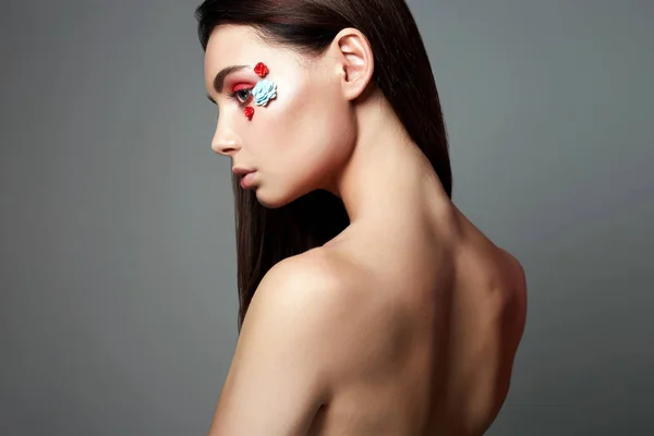 顔に花を持つ美しい少女 裸の背中の若い女性 美容メイク — ストック写真