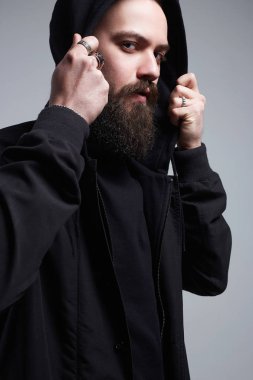 Kukuletalı şık adam. Sakallı yakışıklı çocuk. Şık bir hipster.