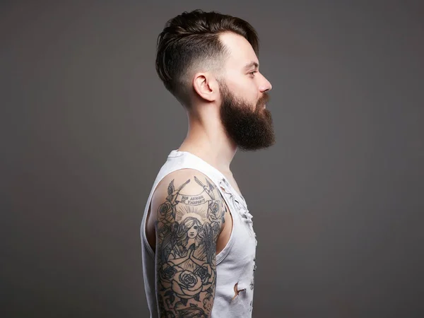 Bearded hipster boy in vintage torn dirty shirt — Stock Photo, Image