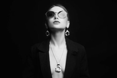 Moda siyah beyaz portresi. Mücevher ve güneş gözlüklü güzel seksi kadın. cinsel kız siyah arkaplan üzerinde