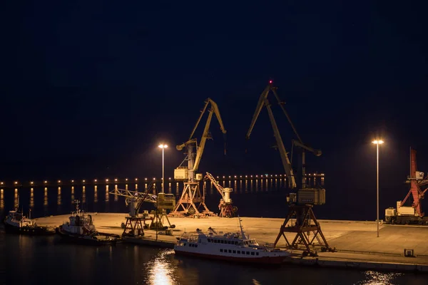 long exposure night photo of cranes in the harbor