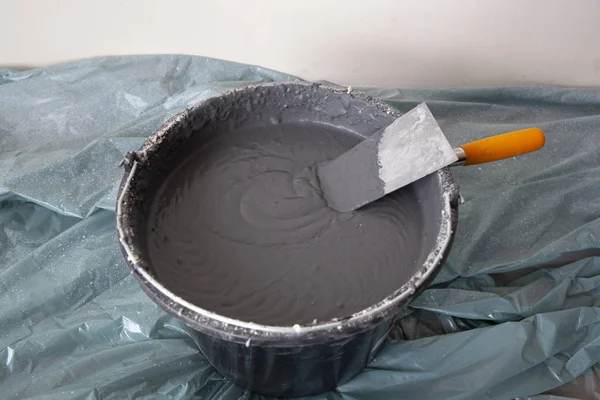 Decorative Plaster and a Trowel in a Bucket