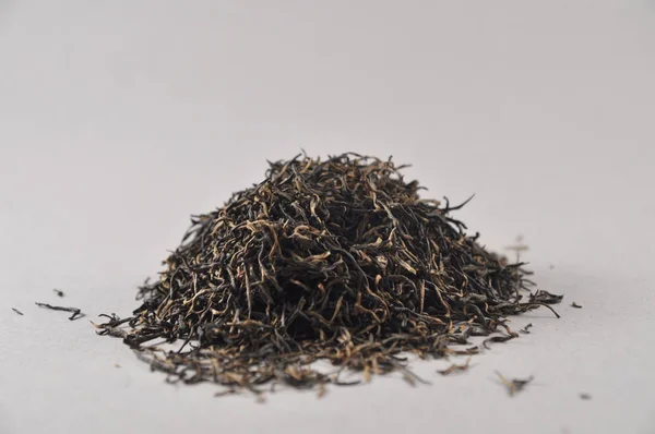 Chinese black tea. Dry tea leaf. Product photo of Chinese tea. Tea and infusions. Heap of dry tea.