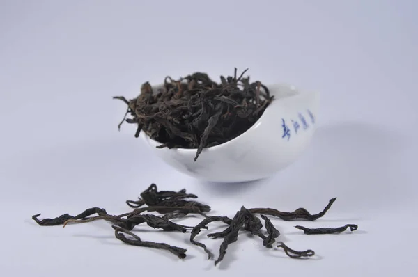 Chinese black tea in tea ware. Dry tea leaf. Product photo of Chinese tea. Tea and infusions. Heap of dry tea.