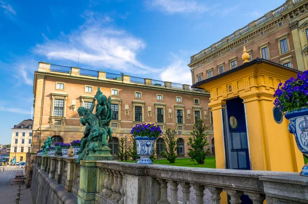 Royal Palace eastern facade (Stockholms slott, Kungliga slottet) Norrbro side, fence, statue, garden in old historical centre Gamla Stan is official residence of Swedish monarch, Stockholm, Sweden