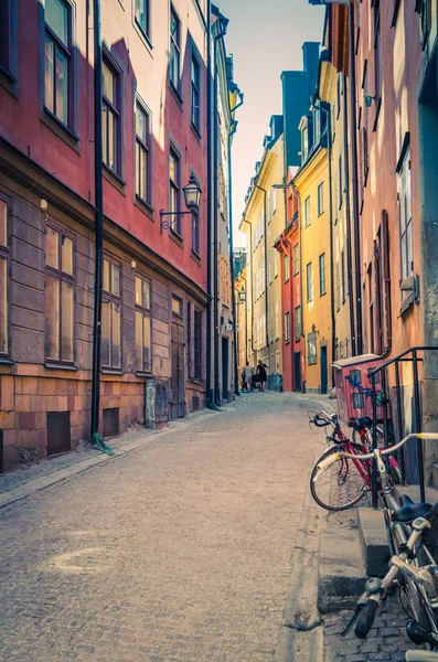 Kaldırım taşları, Bisiklet ve eski tarihi şehir çeyreğinde Gamla Stan Stadsholmen Adası, Stockholm, İsveç renkli binalar geleneksel tipik İsveç dar sokak