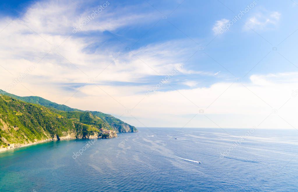 Aerial top panoramic view of Manarola village on cliff and Gulf of Genoa, Ligurian Sea, coastline of Riviera di Levante, National park Cinque Terre, blue sky copy space, La Spezia, Liguria, Italy