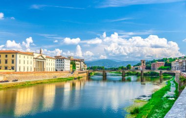 Floransa şehrinin tarihi merkezinde ki set gezinti yolundaki Arno Nehri mavisi üzerindeki Ponte alle Grazie köprüsü, Mavi gökyüzü beyaz bulutları, Toskana, İtalya