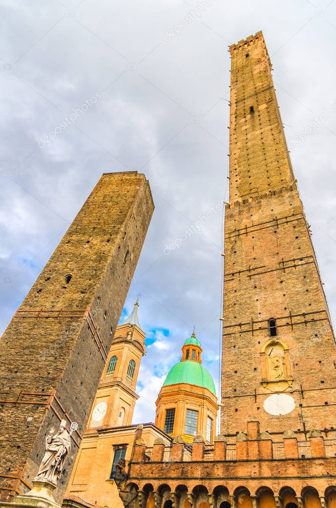 Two medieval towers of Bologna Le Due Torri: Asinelli and Garisenda and Chiesa di San Bartolomeo Gaetano church on Piazza di Porta Ravegnana square in old historical city centre, Emilia-Romagna, Italy