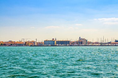 Chioggia şehir merkezindeki deniz lagününden panoramik manzara liman ve tarihi binalar, yaz günü mavi gökyüzü arka planı, Kuzey İtalya, Veneto Bölgesi