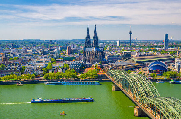 Aerial view of Cologne cityscape of historical city centre with Cologne Cathedral, central railway station Hauptbahnhof and Hohenzollern Bridge across Rhine river, North Rhine-Westphalia, Germany