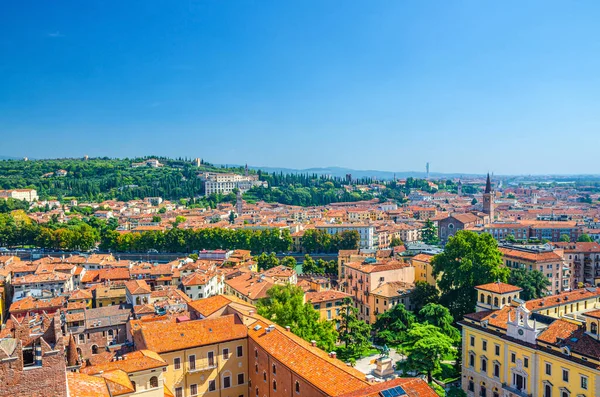 Aerial view of Verona city historical centre Citta Antica with red tiled roof buildings. Panoramic view of cityscape of Verona town. Blue sky background copy space. Veneto Region, Northern Italy