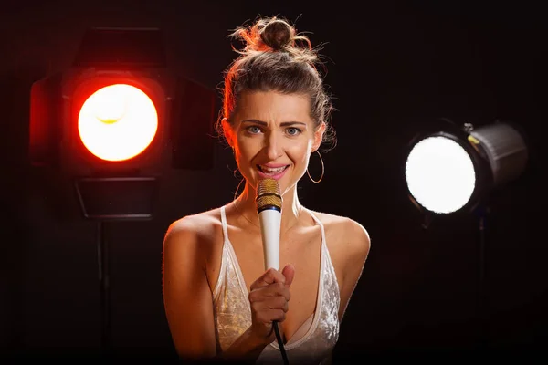 A woman sings a song in the studio