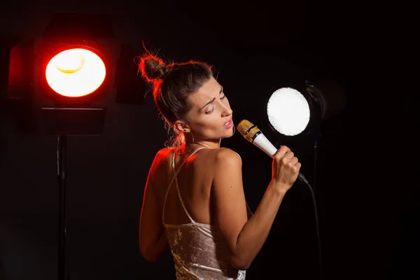 A woman sings a song in the studio