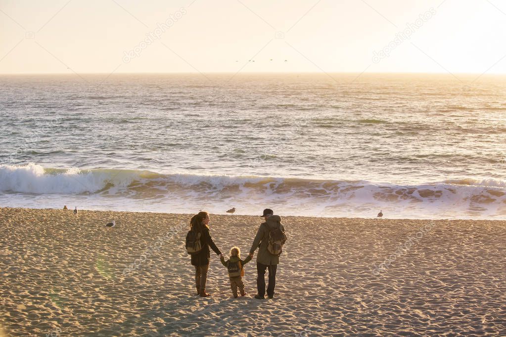 Happy family visit Pacific Ocean in California