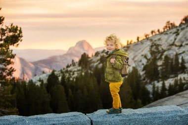Hiker toddler boy visit Yosemite national park in California clipart
